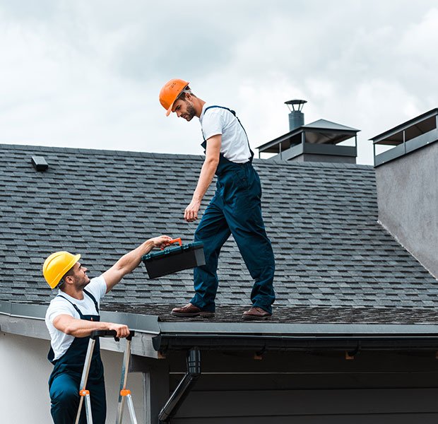 handyman in helmet giving toolbox to handsome coll 2022 11 01 23 12 55 UDC9WLE | Louisiana Roofers