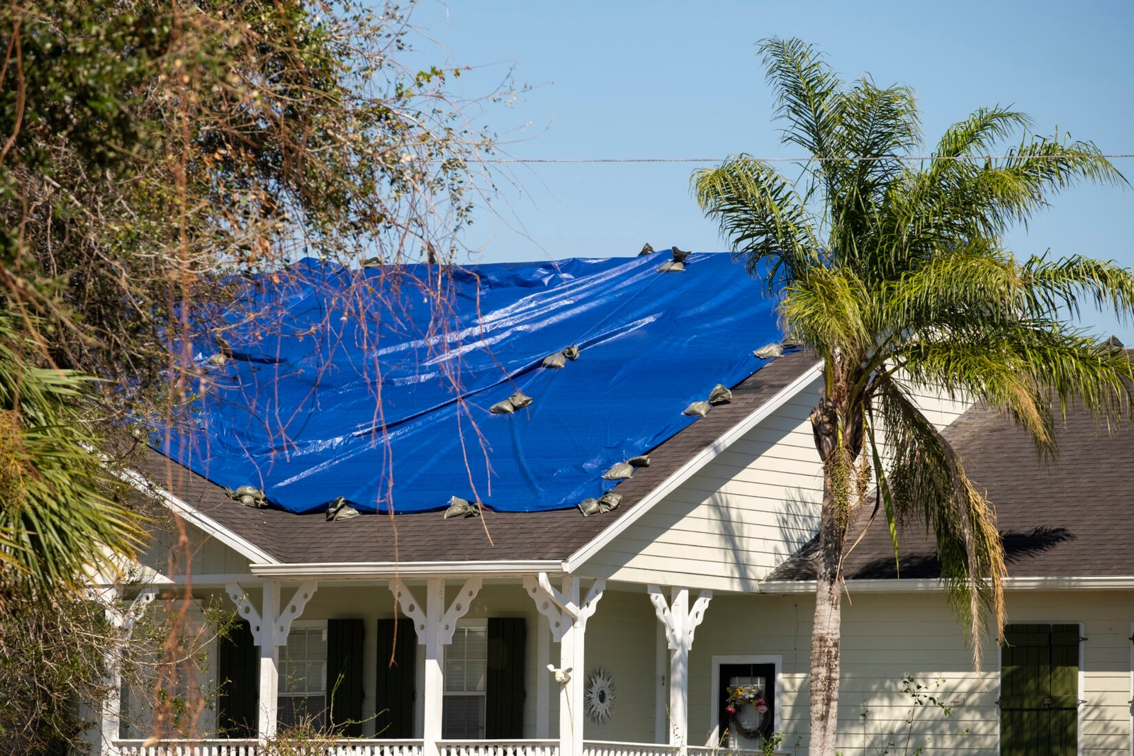 damaged in hurricane house roof covered with blue 2024 12 06 05 01 07 utc | Louisiana Roofers
